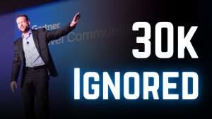 Executive speaker engaging an audience from a conference stage instead of reading slides